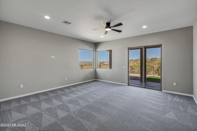 empty room featuring recessed lighting, visible vents, dark colored carpet, and baseboards