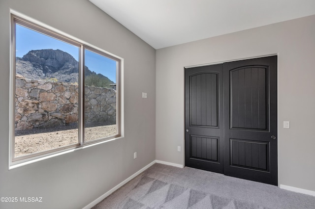 unfurnished bedroom with carpet floors and baseboards