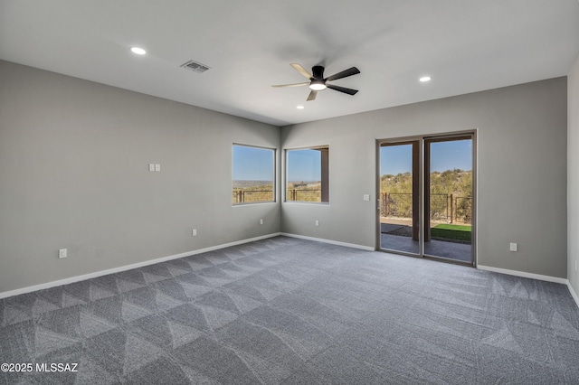 spare room featuring visible vents, recessed lighting, ceiling fan, and dark colored carpet