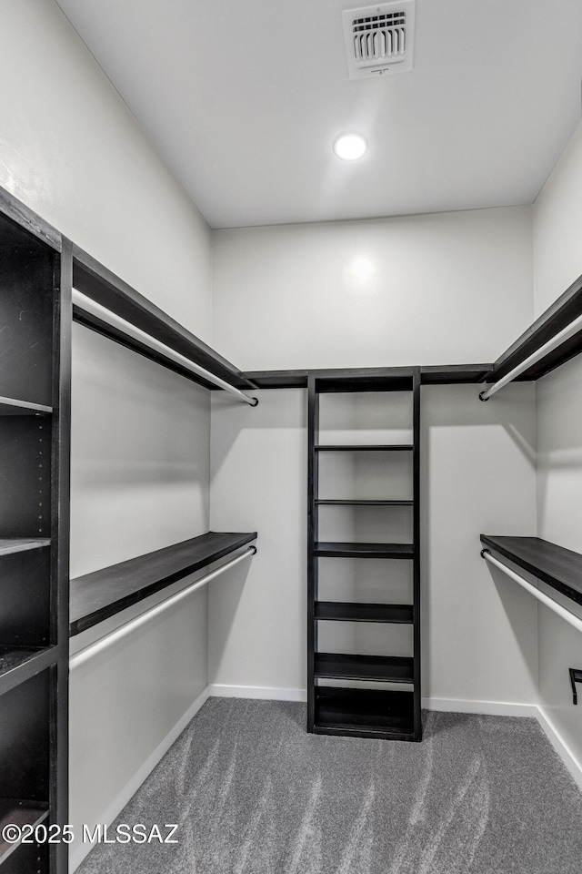 spacious closet with visible vents and dark carpet