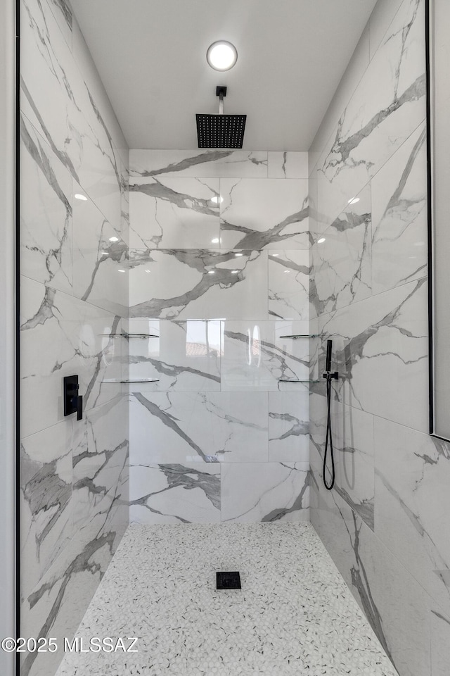bathroom featuring a marble finish shower and recessed lighting