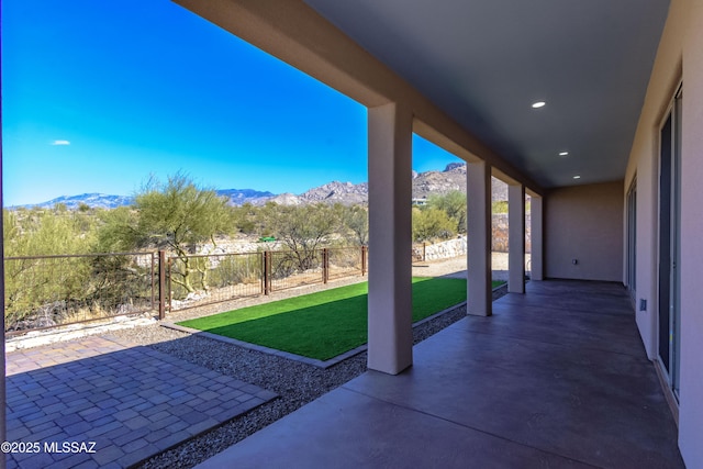 view of patio with a mountain view and a fenced backyard