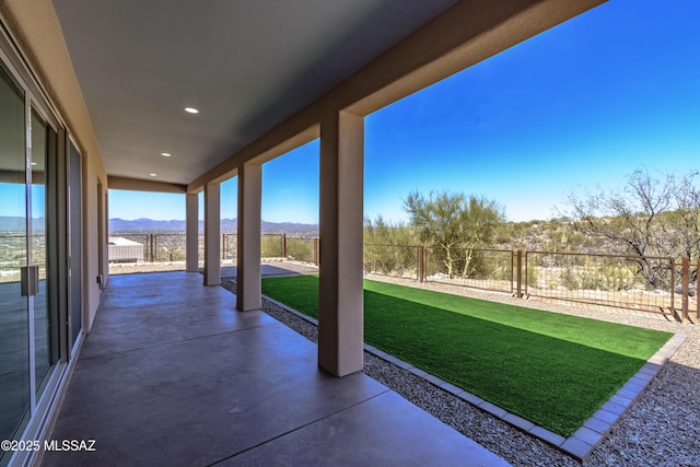 view of patio / terrace featuring a mountain view and a fenced backyard