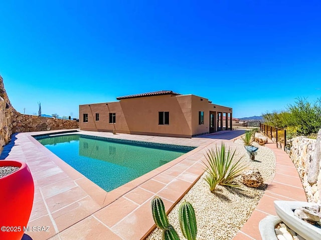 view of swimming pool featuring a patio, a fenced in pool, and fence