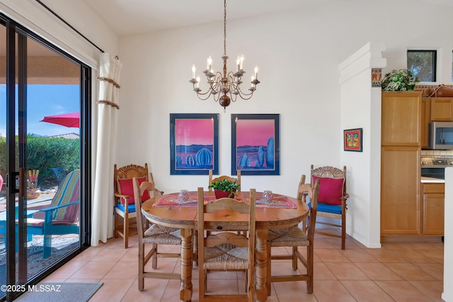 dining room with light tile patterned floors and an inviting chandelier