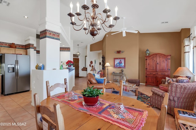 dining space with high vaulted ceiling, visible vents, and light tile patterned floors