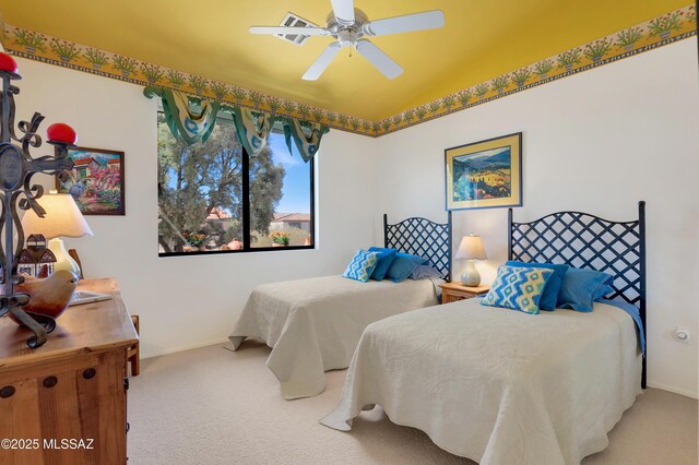 bedroom with light carpet, ceiling fan, and baseboards