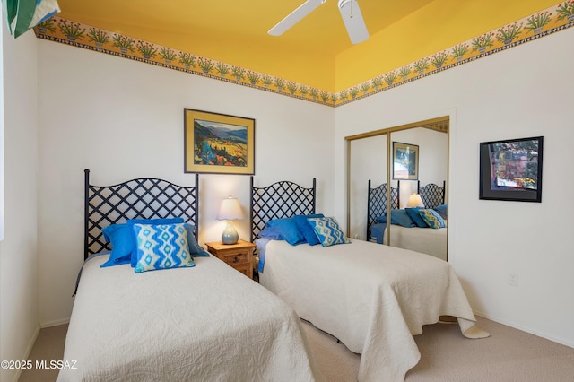 bedroom with carpet floors, a closet, a ceiling fan, and baseboards