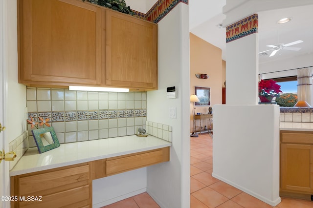 kitchen with light tile patterned floors, light countertops, tasteful backsplash, and ceiling fan