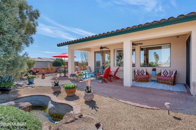 view of patio featuring ceiling fan and fence