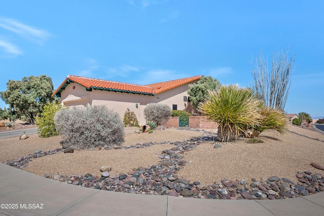 view of front of home with a tile roof and stucco siding