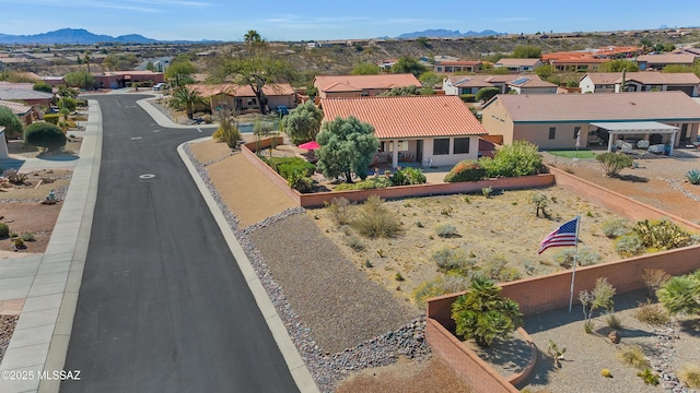 drone / aerial view featuring a residential view and a mountain view