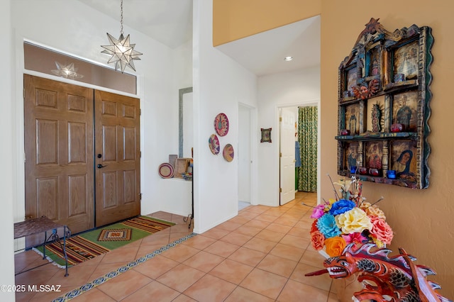 entrance foyer with an inviting chandelier and tile patterned floors