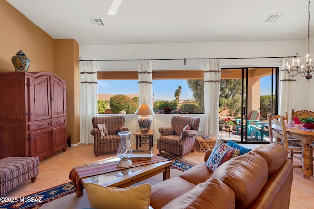 living area with a healthy amount of sunlight, visible vents, a notable chandelier, and light tile patterned flooring