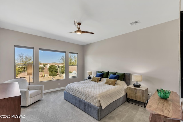 bedroom with a ceiling fan, baseboards, visible vents, and light carpet