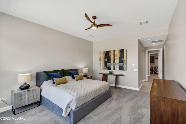 bedroom featuring visible vents, baseboards, washer and clothes dryer, carpet flooring, and a ceiling fan