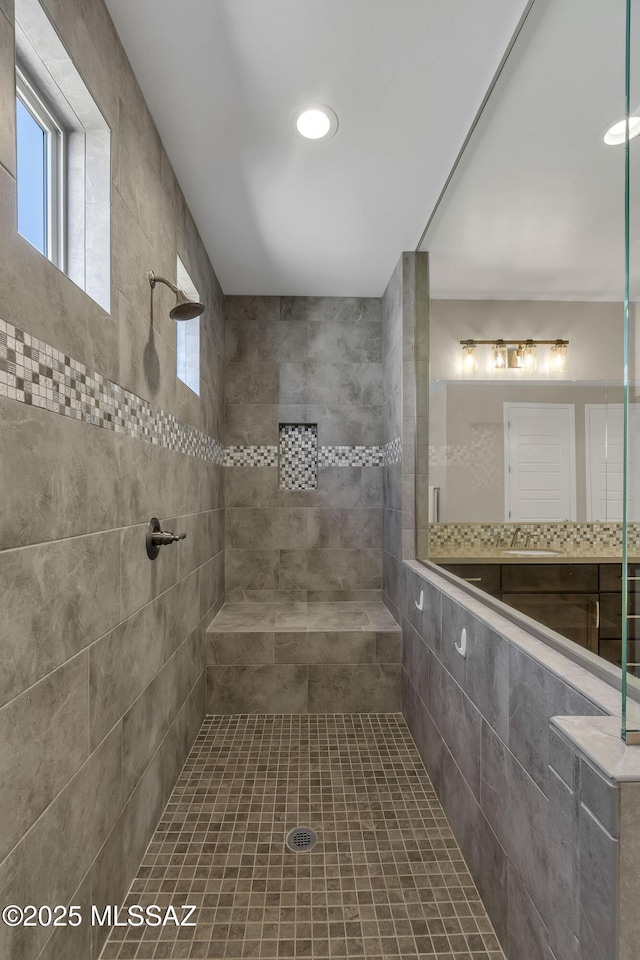 bathroom with a tile shower and recessed lighting