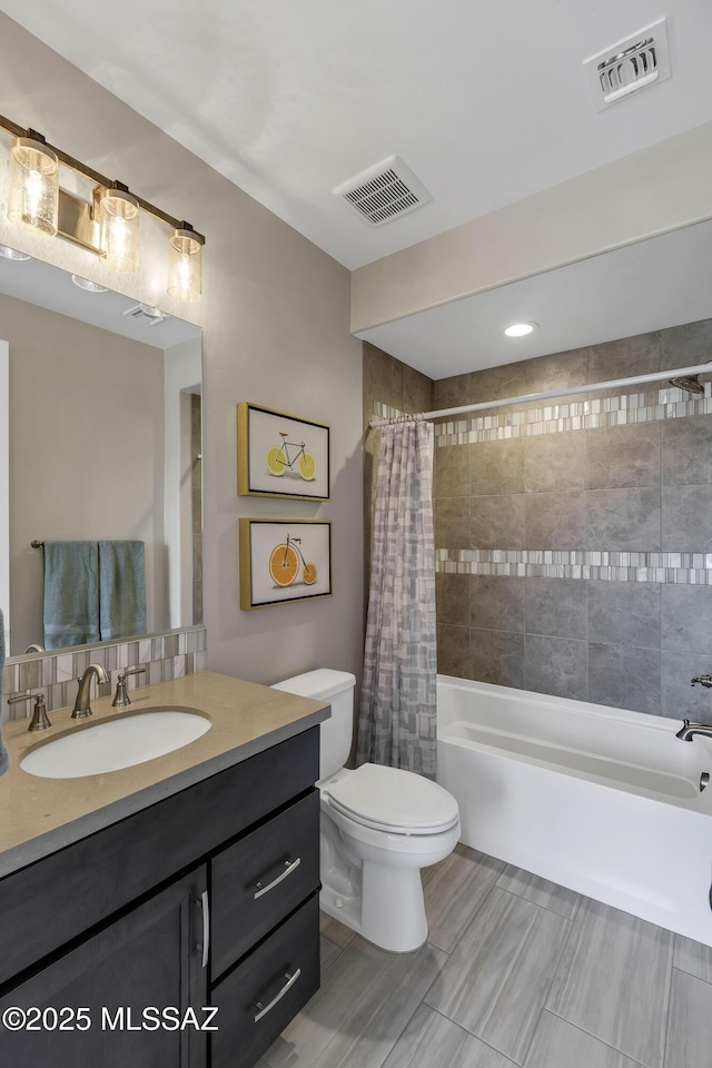 full bath featuring visible vents, toilet, shower / bath combo with shower curtain, and vanity