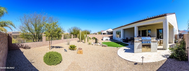 view of yard with ceiling fan, area for grilling, a fenced backyard, and a patio area