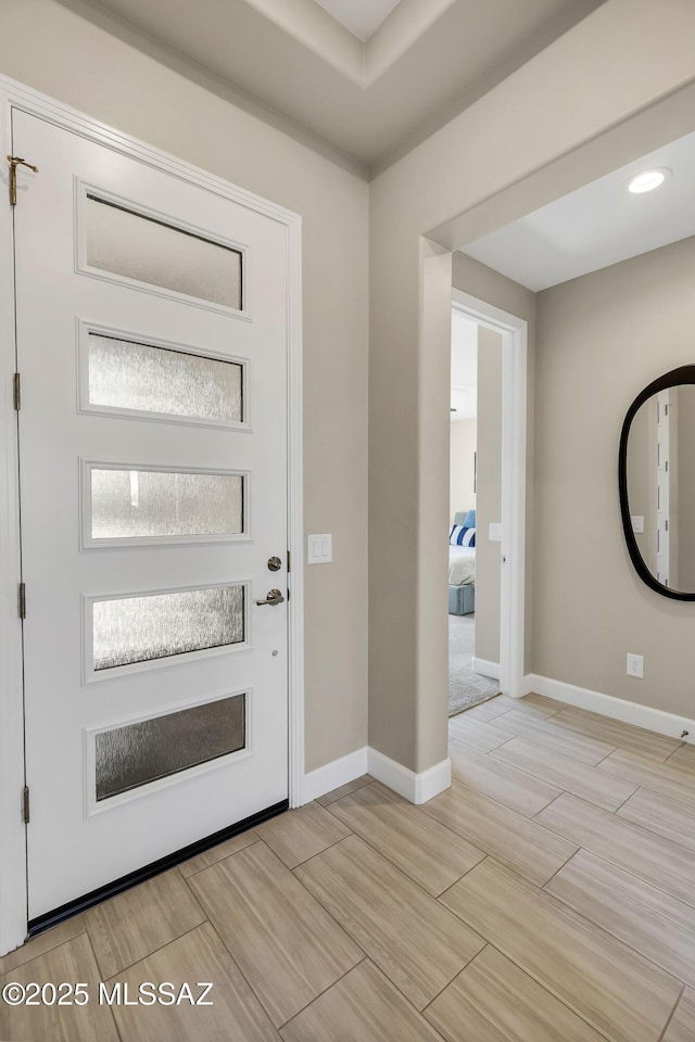 foyer entrance with baseboards