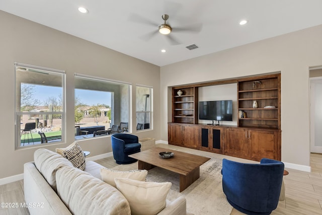 living area featuring recessed lighting, baseboards, and visible vents