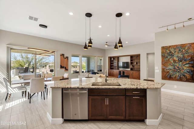 kitchen with visible vents, a sink, open floor plan, stainless steel dishwasher, and a kitchen island with sink