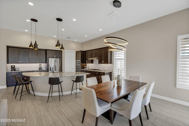 dining area featuring recessed lighting and baseboards