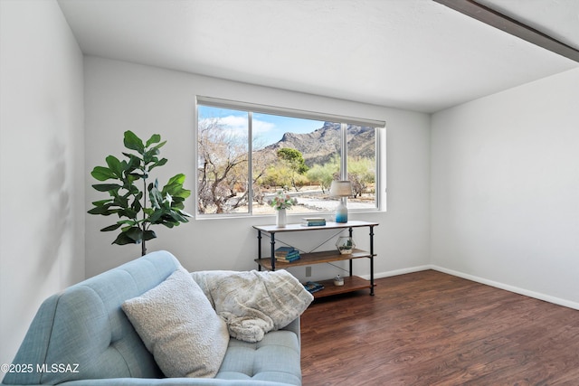 living area with baseboards and wood finished floors