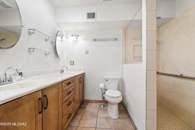 bathroom featuring walk in shower, visible vents, and a sink