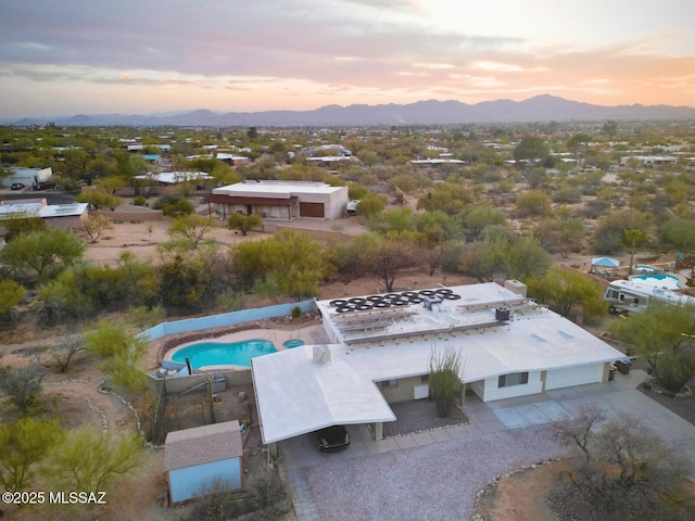 aerial view at dusk featuring a mountain view