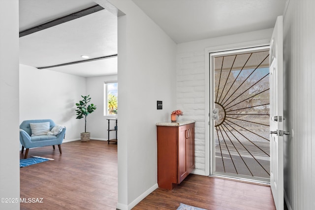 entrance foyer featuring dark wood-style floors and baseboards