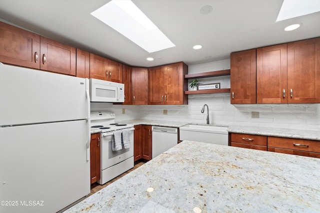 kitchen with a sink, light stone counters, decorative backsplash, white appliances, and open shelves