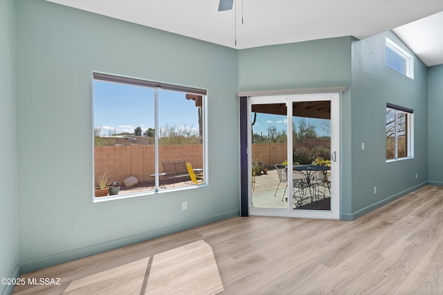 empty room with ceiling fan, baseboards, and wood finished floors