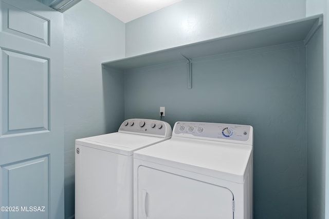 laundry room featuring washing machine and dryer and laundry area