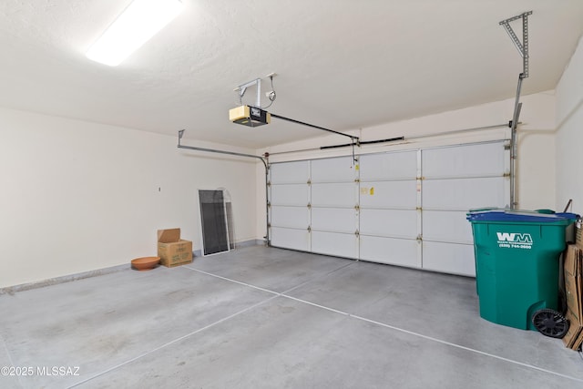 garage with baseboards and a garage door opener