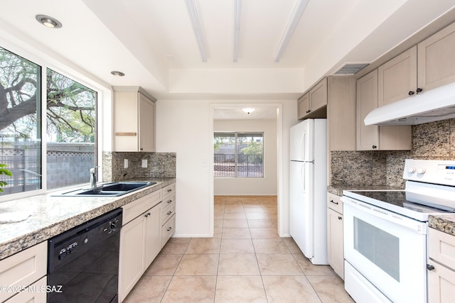 kitchen featuring white appliances, light tile patterned floors, visible vents, a sink, and under cabinet range hood