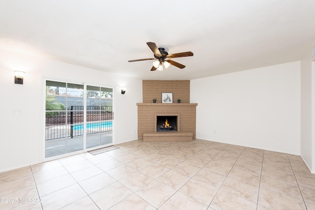 unfurnished living room with light tile patterned floors, ceiling fan, and a fireplace