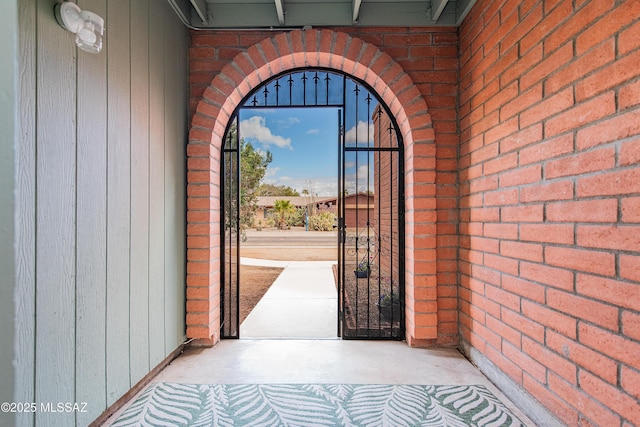 entrance to property featuring brick siding