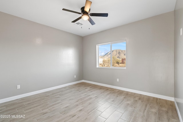 unfurnished room featuring visible vents, baseboards, light wood-style floors, and a ceiling fan