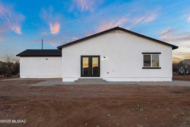 back of property with french doors, entry steps, and stucco siding