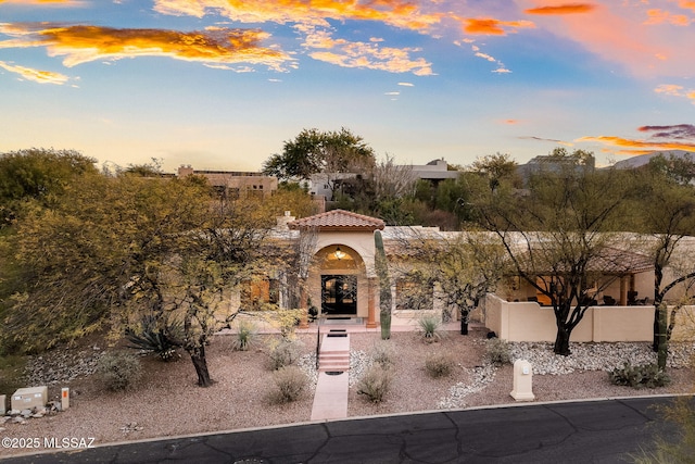 exterior space with a tiled roof and stucco siding