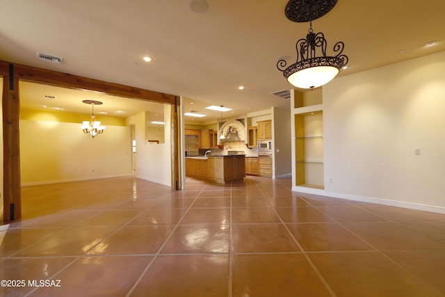 interior space with light tile patterned floors, built in shelves, recessed lighting, visible vents, and baseboards