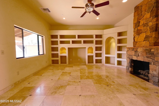 unfurnished living room featuring built in shelves, a fireplace, visible vents, baseboards, and a ceiling fan