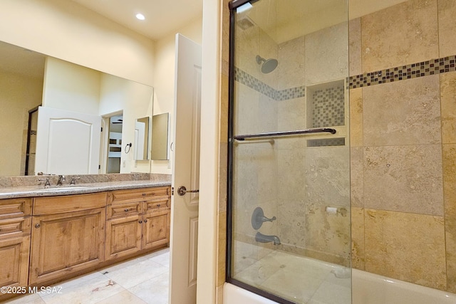 full bath featuring tile patterned flooring, vanity, and bath / shower combo with glass door