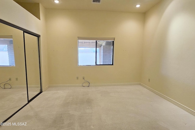 empty room featuring carpet flooring and baseboards