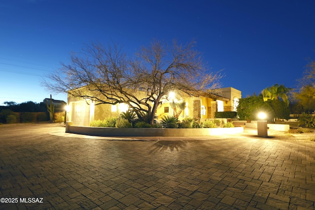 view of front of home with decorative driveway and an attached garage