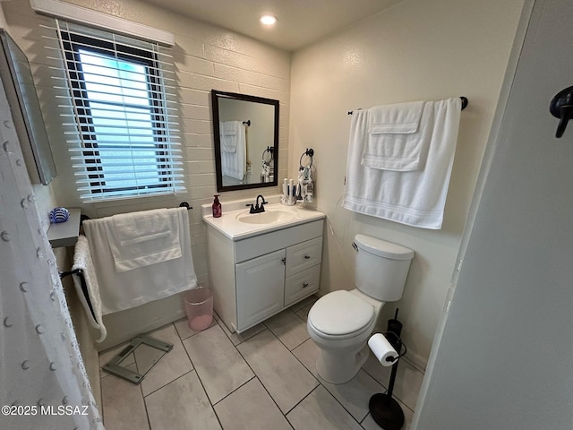 bathroom featuring vanity, toilet, and tile patterned floors