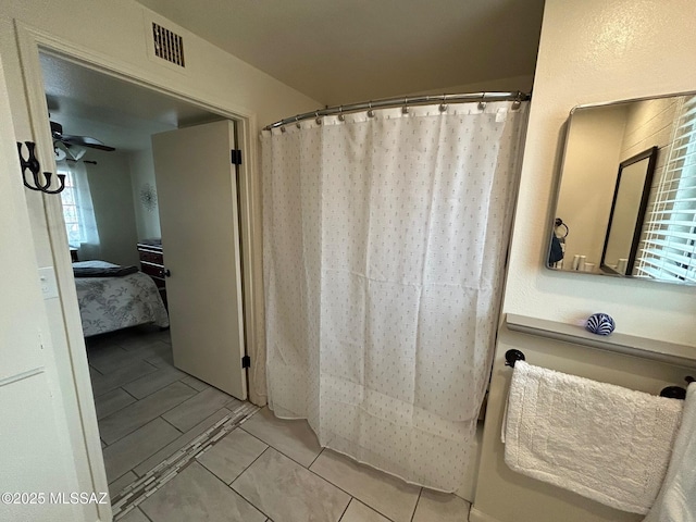 bathroom featuring a shower with curtain, connected bathroom, visible vents, and a ceiling fan