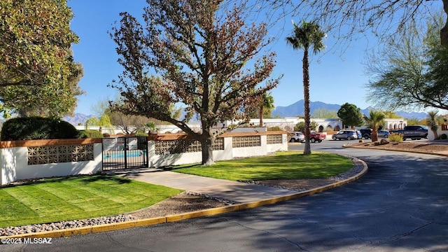 view of road featuring a gate and a mountain view