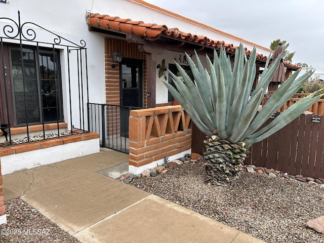 view of exterior entry with a tile roof